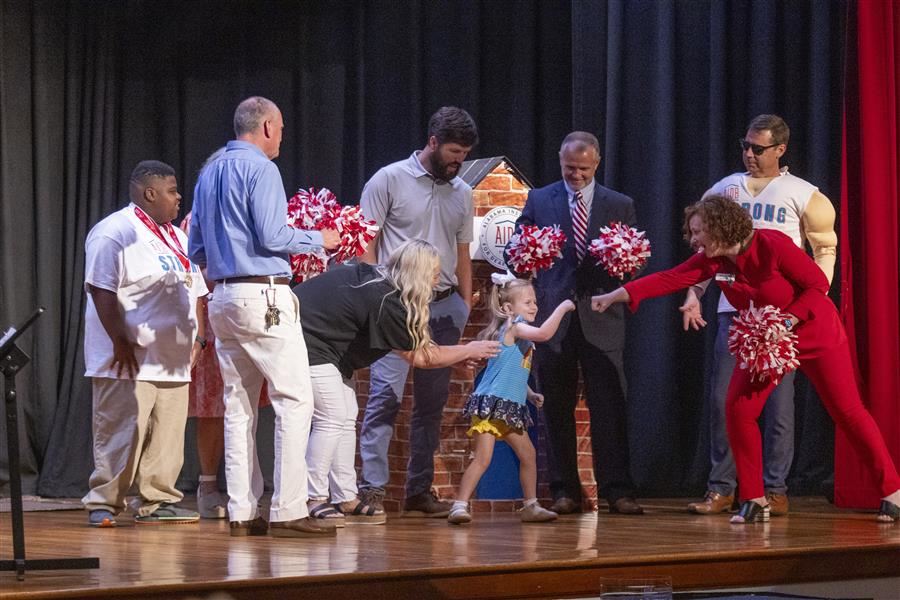  AIDB representatives cheer on Landry Kate and her parents during the convocation skit.